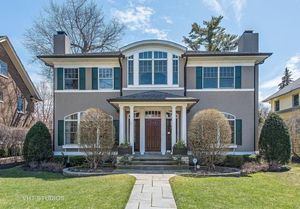 Image of Two Story Grey Home, with blue shutters and red front door.